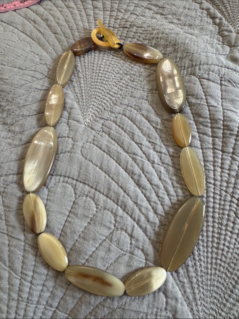vintage statement necklace featuring chunky, light tan, translucent oval beads